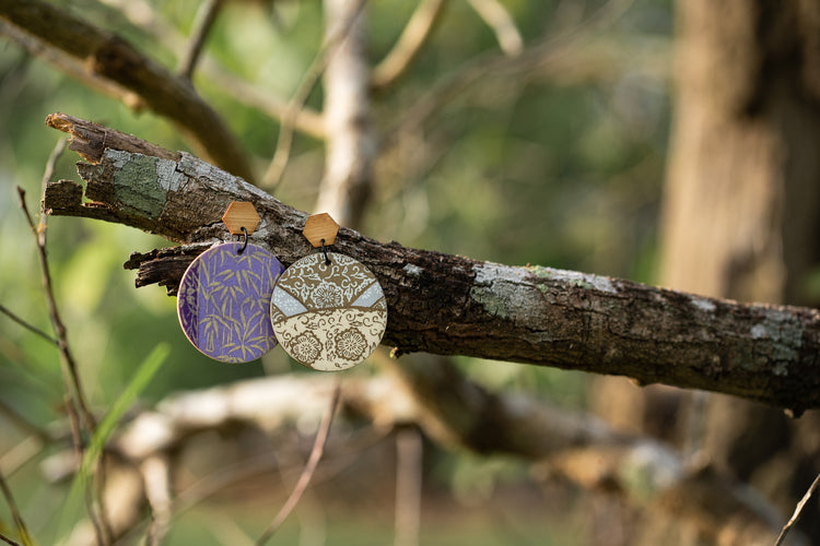 Wood decoupage earrings handmade by Mariye in Darwin, photographed on a tree